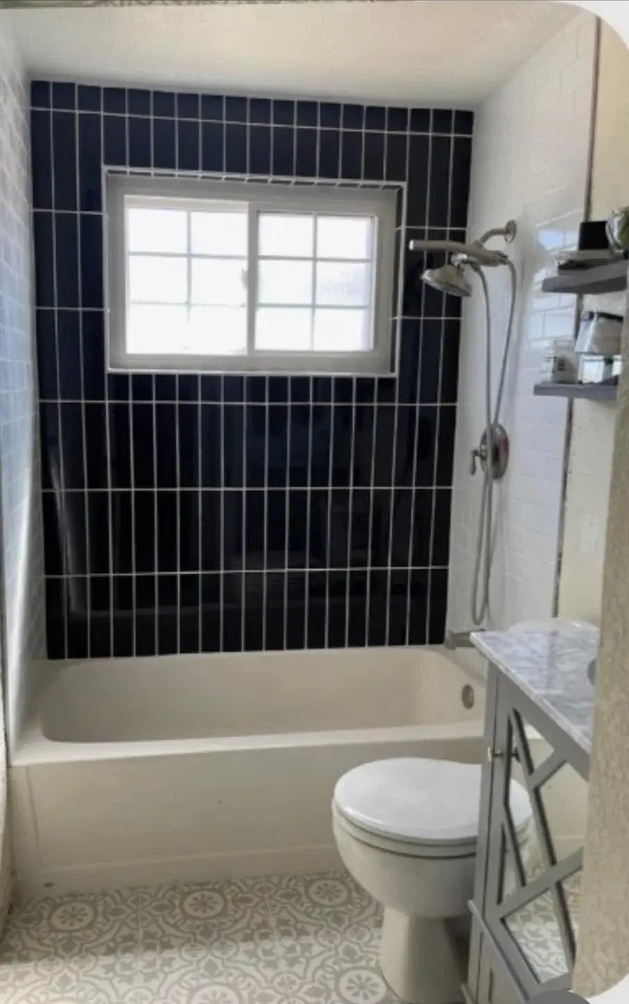 Tempe bathroom remodel with navy stacked vertical tile shower wall, tub-shower combo, and decorative cement-tile floor by Zona Floors