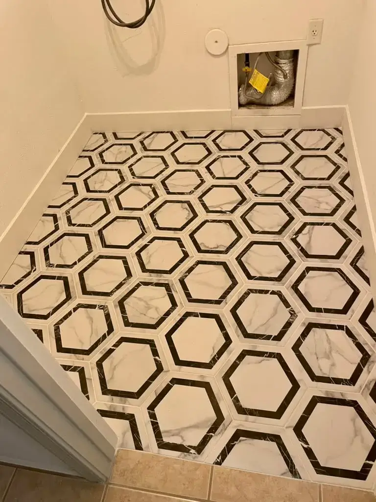 Custom geometric hexagon marble natural stone floor with black marble accents and white square inserts installed by Zona Floors in an Arizona home
