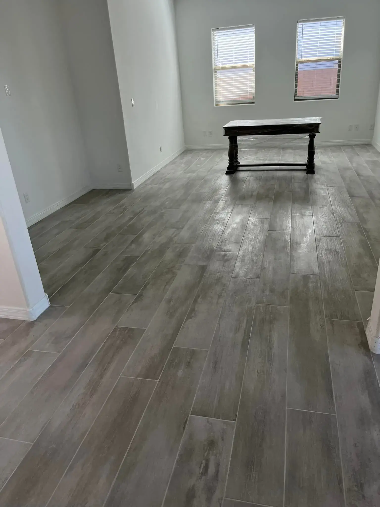 Finished Arizona room with gray wood-look porcelain tile flooring installed by Zona Floors