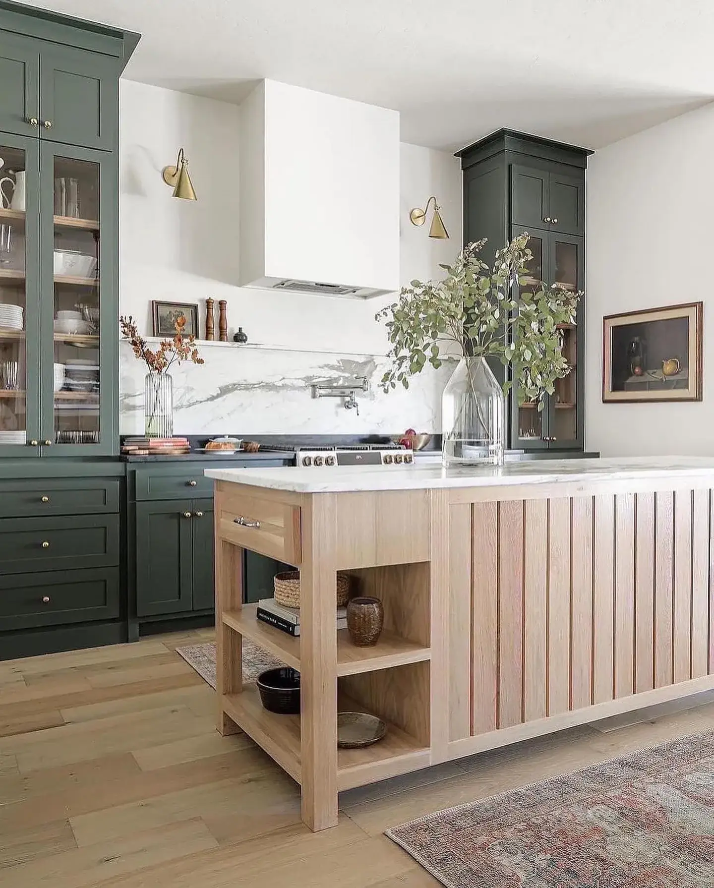 Full kitchen remodel with hunter-green shaker cabinets, full-height marble backsplash, white range hood, and slatted oak island by Zona Floors in Arizona